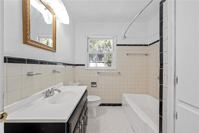 full bathroom featuring tile patterned flooring, a textured ceiling, toilet, vanity, and tile walls