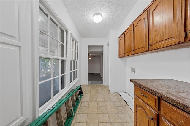 laundry area with cabinets, washer hookup, a textured ceiling, and ceiling fan