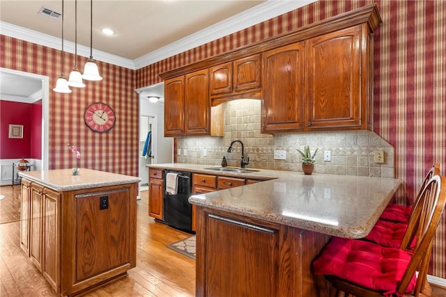 kitchen featuring a center island, sink, crown molding, hanging light fixtures, and black dishwasher