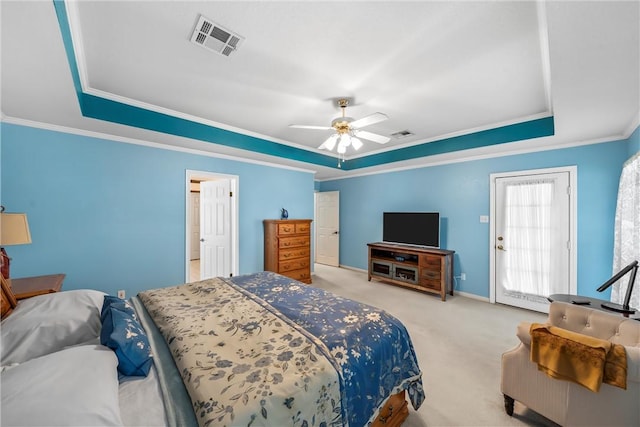 bedroom with ceiling fan, a raised ceiling, light carpet, and crown molding