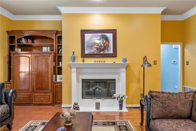 living room with light wood-type flooring and ornamental molding