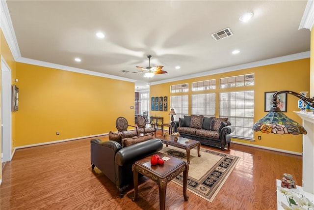 living room with ceiling fan, wood-type flooring, and ornamental molding