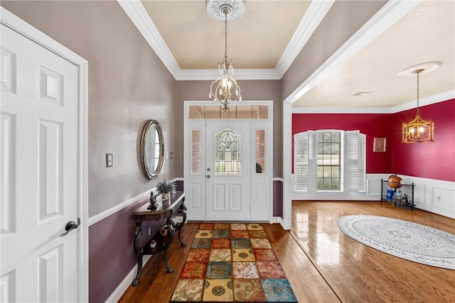 entrance foyer featuring wood-type flooring and crown molding