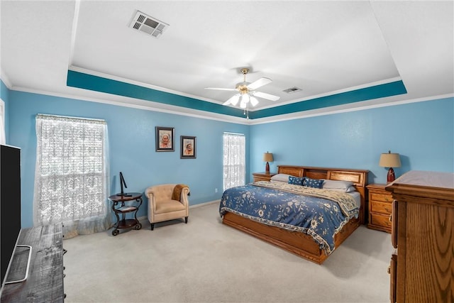 bedroom featuring light carpet, a raised ceiling, ceiling fan, and crown molding