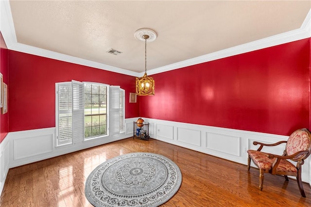 dining area featuring a chandelier, hardwood / wood-style floors, and crown molding