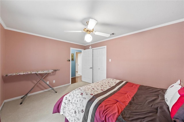 bedroom with a closet, light colored carpet, ceiling fan, and ornamental molding