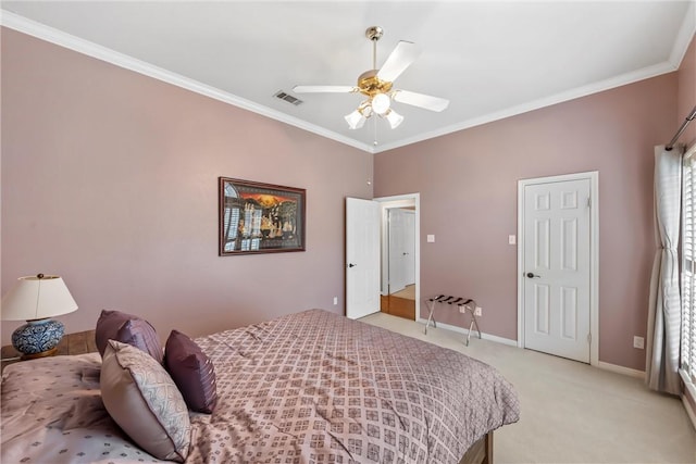 carpeted bedroom featuring ceiling fan and crown molding