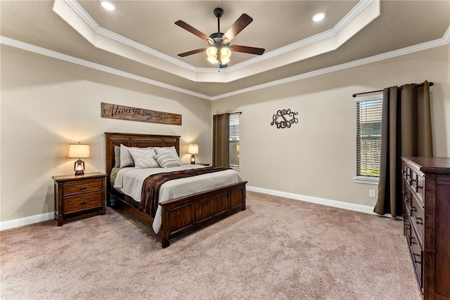 carpeted bedroom featuring a raised ceiling, ceiling fan, and ornamental molding