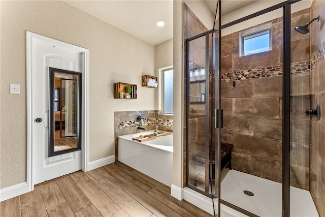 bathroom featuring decorative backsplash, hardwood / wood-style floors, and independent shower and bath