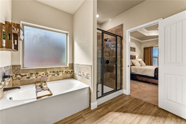 bathroom featuring separate shower and tub and ornamental molding