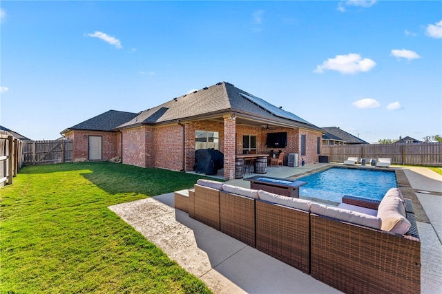 view of pool featuring a bar, a patio area, and a lawn