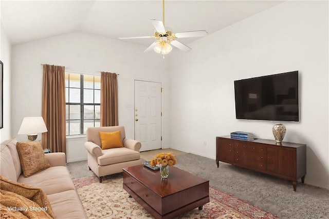 carpeted living area with a ceiling fan, vaulted ceiling, and baseboards