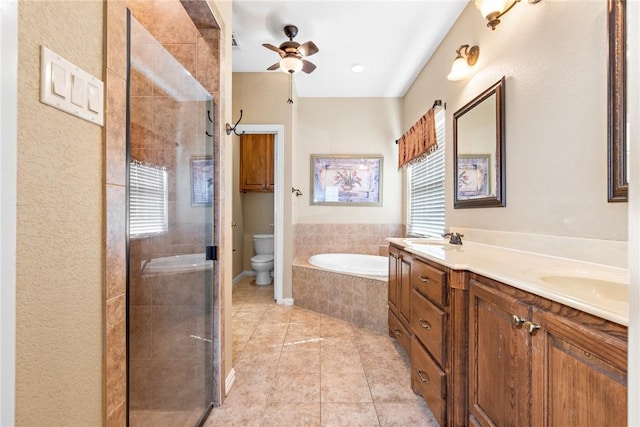 bathroom with tile patterned flooring, toilet, a sink, double vanity, and a stall shower