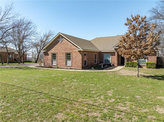 view of front of house featuring a front yard and brick siding