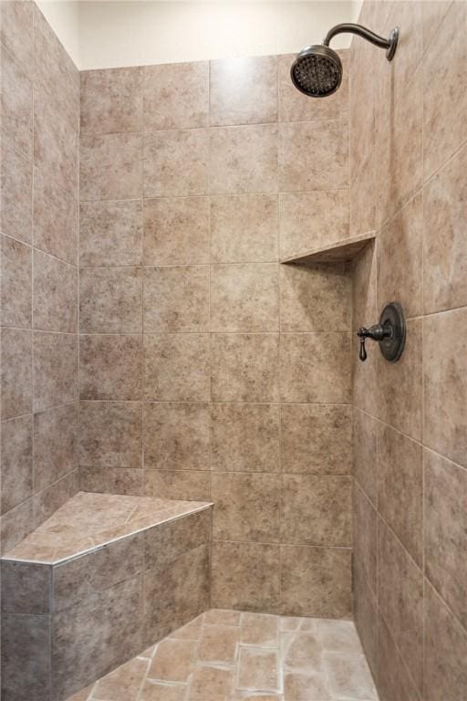 full bathroom featuring tiled shower