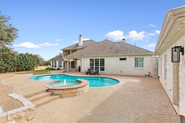 view of swimming pool featuring an in ground hot tub and a patio