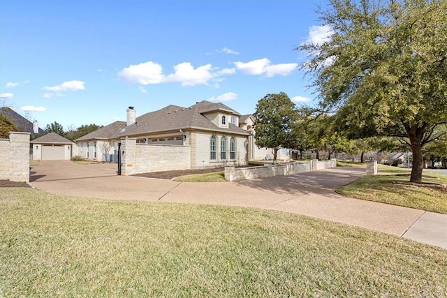 view of front of home with a front yard and a garage