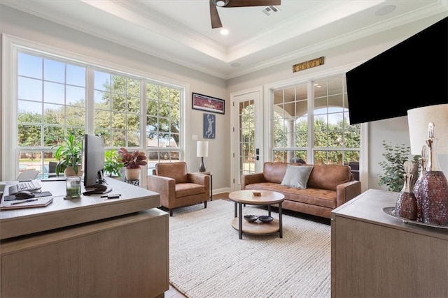 sunroom featuring ceiling fan and a tray ceiling