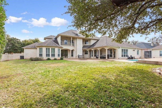 back of property featuring a lawn and a patio area