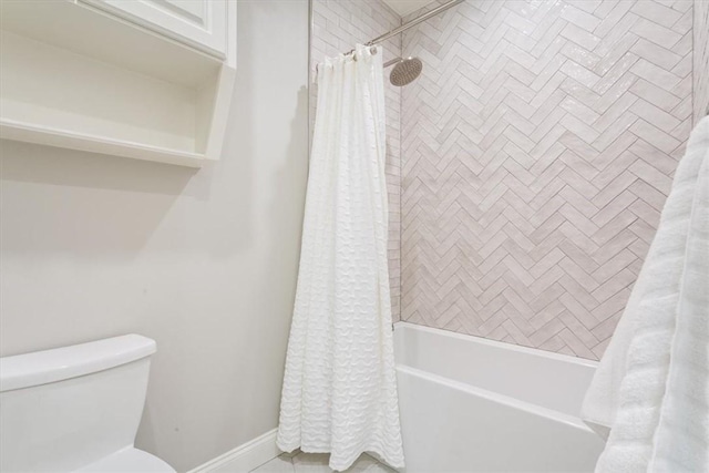 bathroom featuring toilet and shower / bath combination with curtain