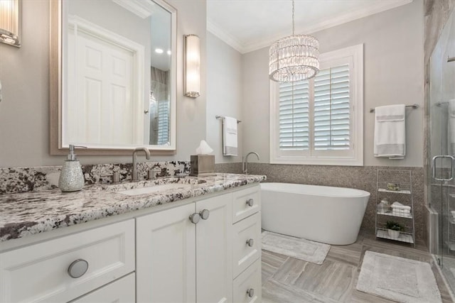 bathroom with separate shower and tub, vanity, tile patterned flooring, an inviting chandelier, and ornamental molding