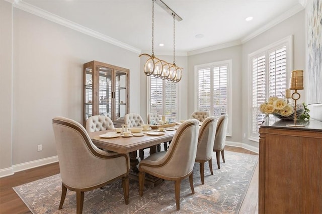 dining room with dark wood-type flooring, crown molding, and a chandelier