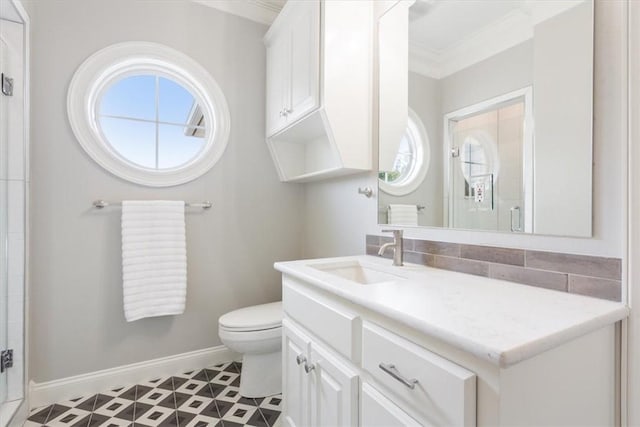 bathroom with an enclosed shower, vanity, toilet, and ornamental molding