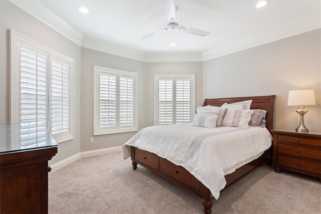 carpeted bedroom featuring ceiling fan and crown molding