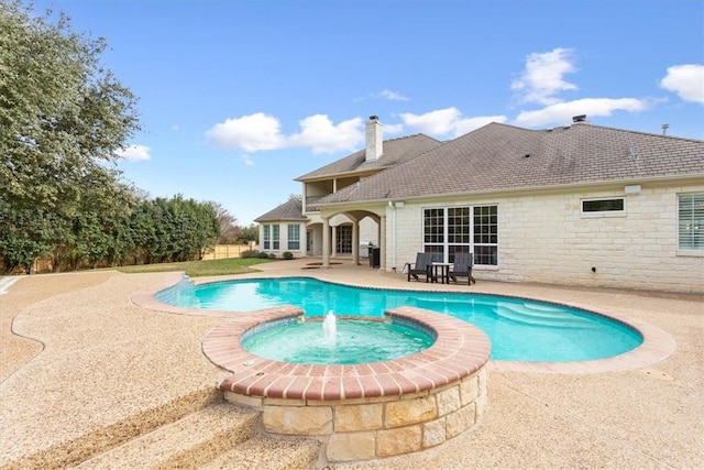 view of pool featuring a patio area and an in ground hot tub