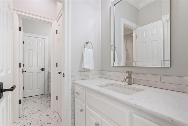 bathroom with ornamental molding, tile walls, and vanity