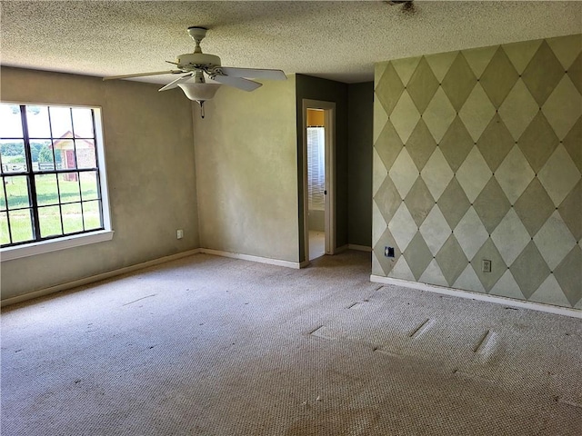 unfurnished room with a textured ceiling, light colored carpet, and ceiling fan