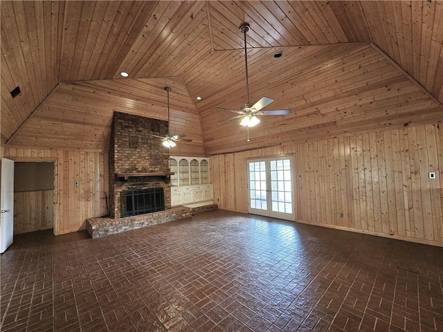 unfurnished living room with ceiling fan, a brick fireplace, high vaulted ceiling, wood walls, and wood ceiling