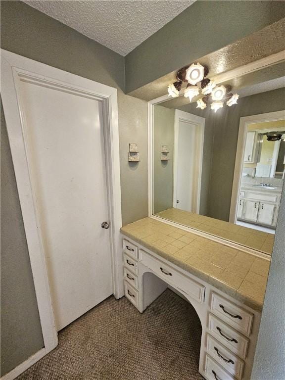 bathroom featuring vanity and a textured ceiling