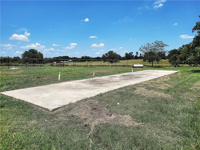 view of home's community with a rural view and a yard