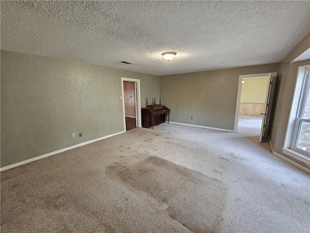 unfurnished bedroom with carpet flooring and a textured ceiling