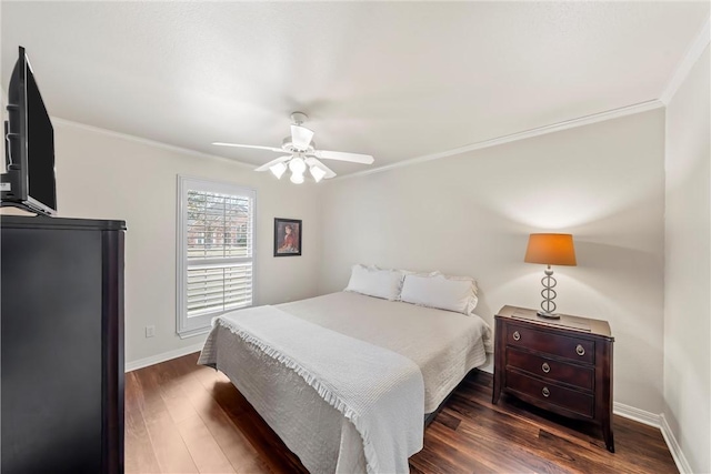 bedroom with ceiling fan, dark hardwood / wood-style flooring, and crown molding