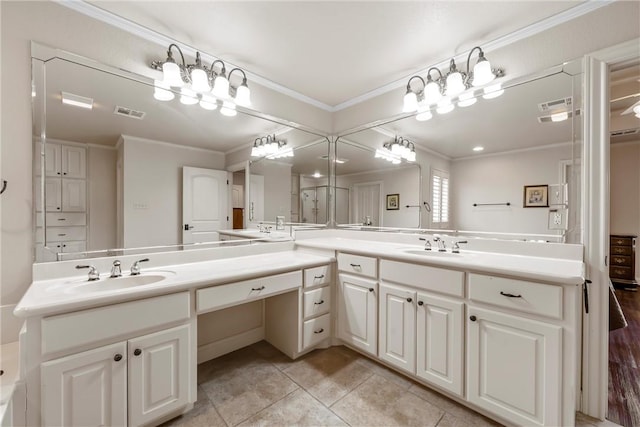 bathroom featuring vanity, crown molding, and tile patterned flooring