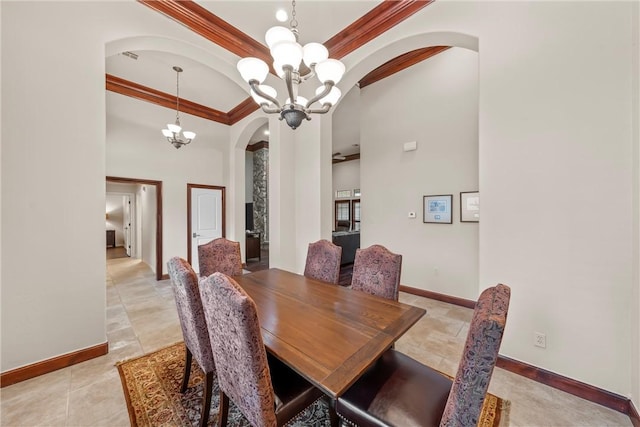 dining space featuring an inviting chandelier, crown molding, and a towering ceiling