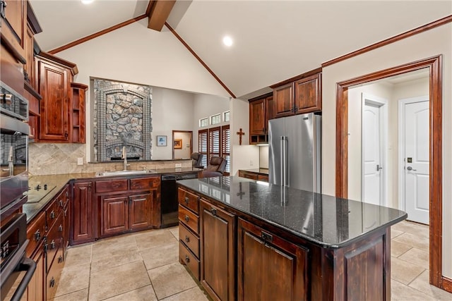 kitchen featuring a center island, decorative backsplash, sink, beamed ceiling, and appliances with stainless steel finishes