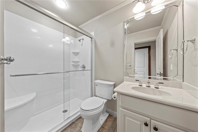 bathroom featuring toilet, vanity, tile patterned floors, ornamental molding, and an enclosed shower