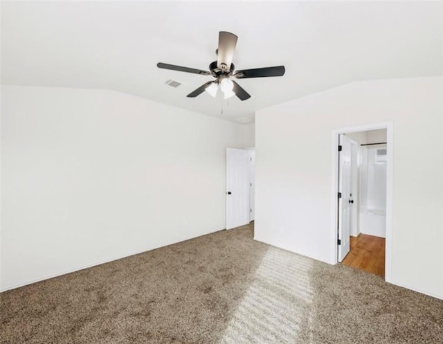 unfurnished bedroom with carpet flooring, vaulted ceiling, and ceiling fan