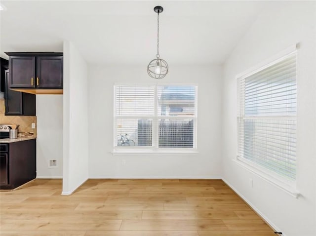 unfurnished dining area with light hardwood / wood-style floors