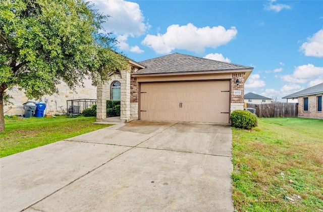 view of front facade featuring a garage and a front lawn