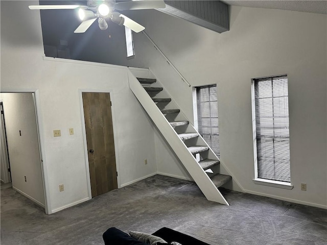 stairs featuring carpet floors, high vaulted ceiling, and ceiling fan