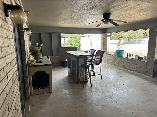 interior space with ceiling fan and concrete floors