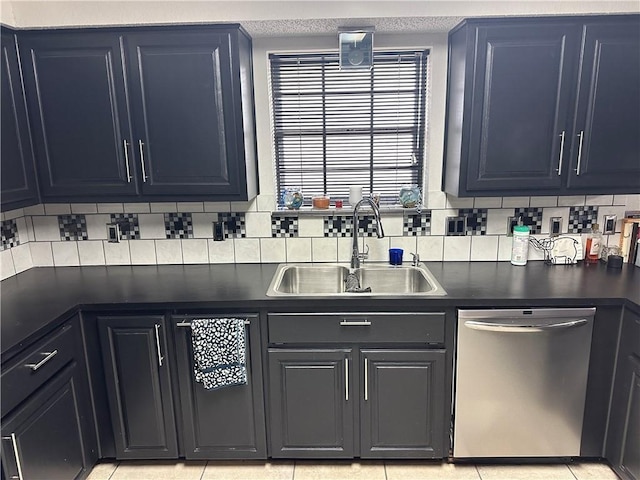 kitchen featuring stainless steel dishwasher, light tile patterned floors, sink, and tasteful backsplash