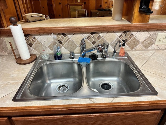 room details featuring decorative backsplash and sink