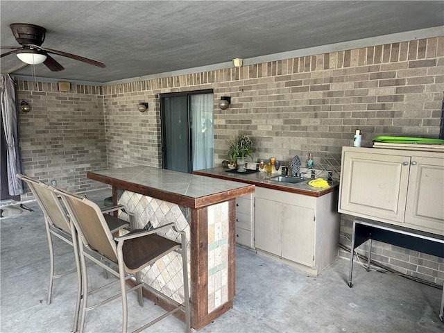 view of patio / terrace featuring ceiling fan and an outdoor wet bar