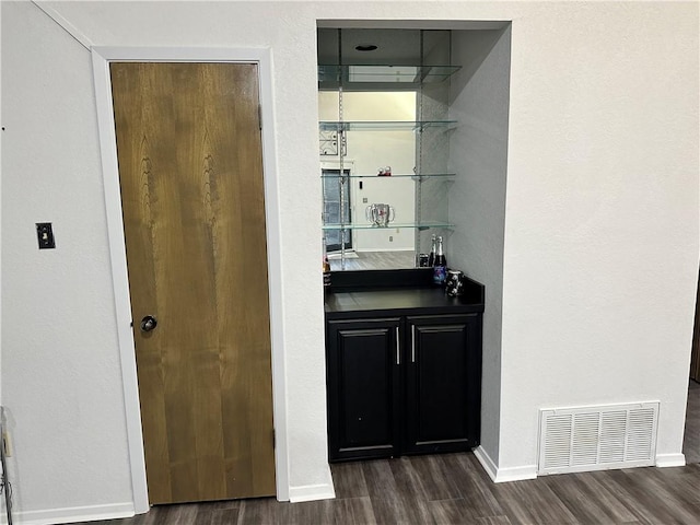 bar with dark hardwood / wood-style floors