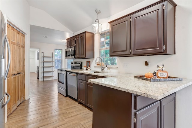 kitchen featuring dark brown cabinets, stainless steel appliances, sink, light hardwood / wood-style floors, and lofted ceiling